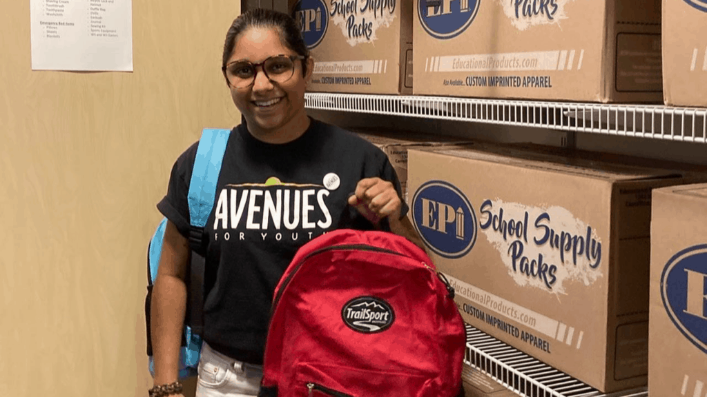 Staff holding a backpack